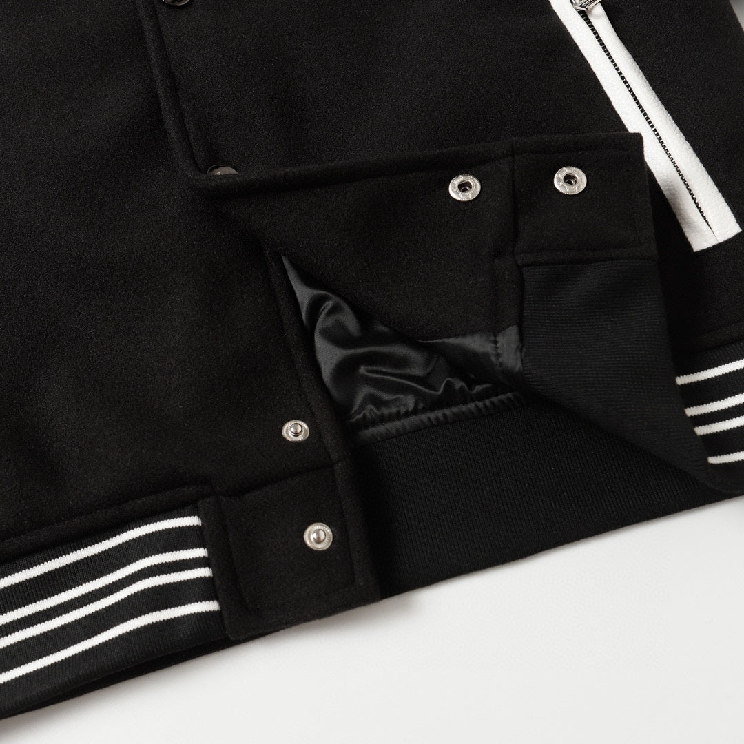 Black jacket with snap placket, lining, and striped ribbed cuff