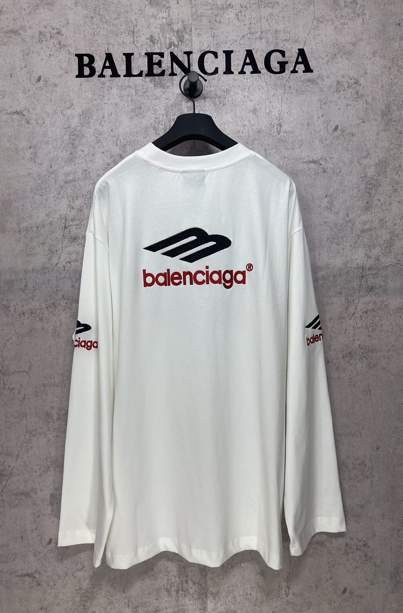 White long-sleeve T-shirt with black and red Balenciaga logo on back