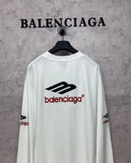 White long-sleeve T-shirt back view with black emblem and red Balenciaga logo