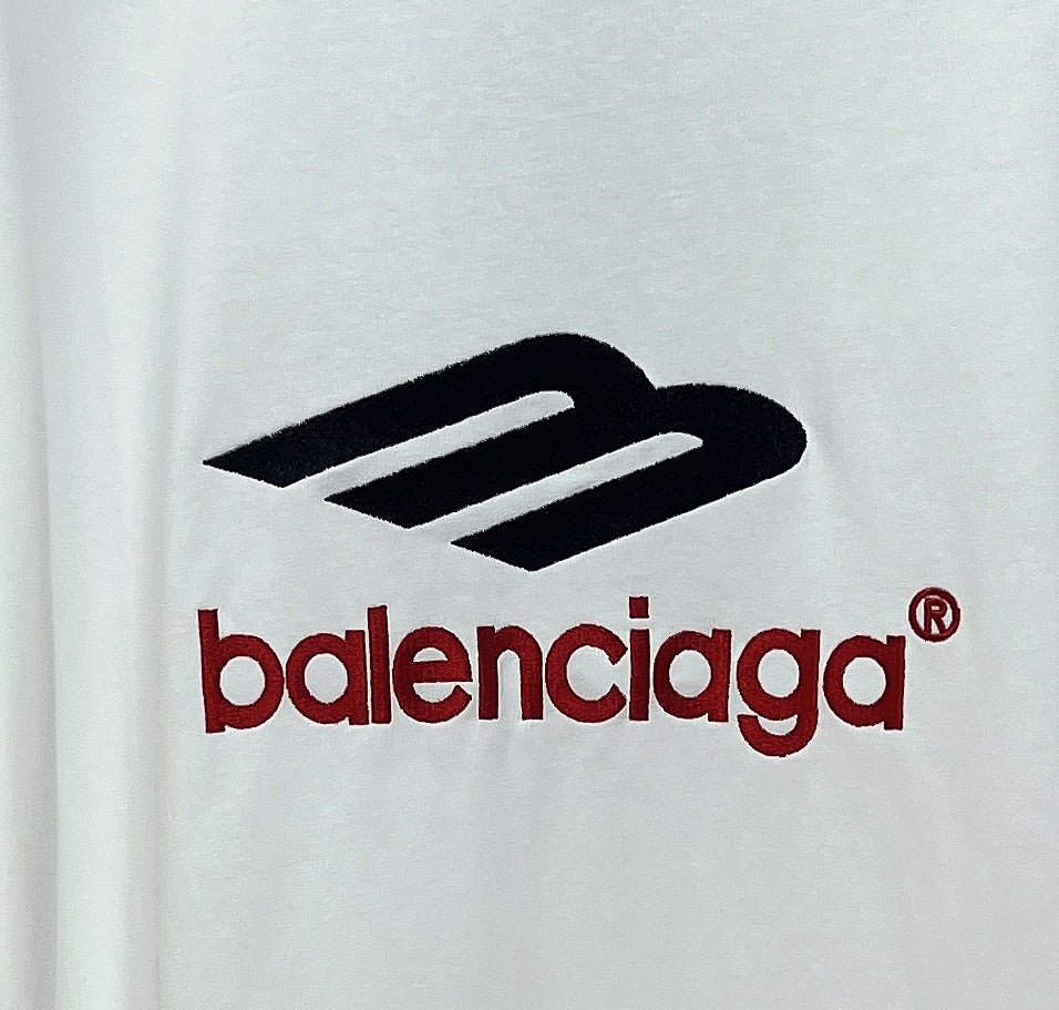 White long-sleeve T-shirt close-up of black emblem and red Balenciaga wordmark