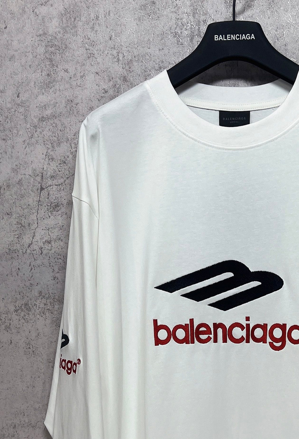 White long-sleeve T-shirt with black-and-red Balenciaga logo and sleeve print marks