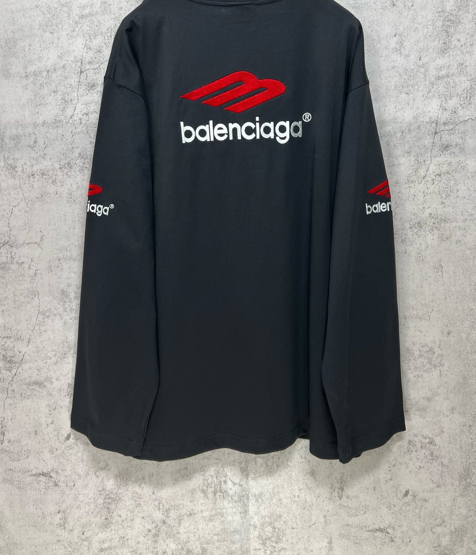 Balenciaga long-sleeve T-shirt, dark navy, back view with red logo above the wordmark