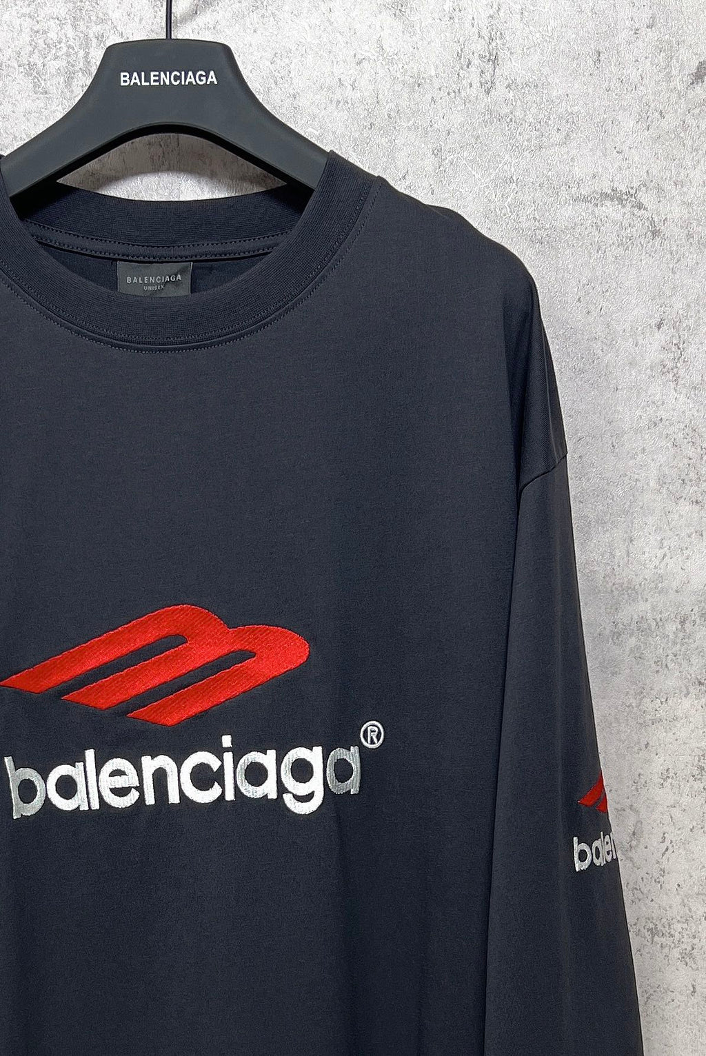 Balenciaga long-sleeve T-shirt, dark navy, close-up of crew neckline and red logo on front