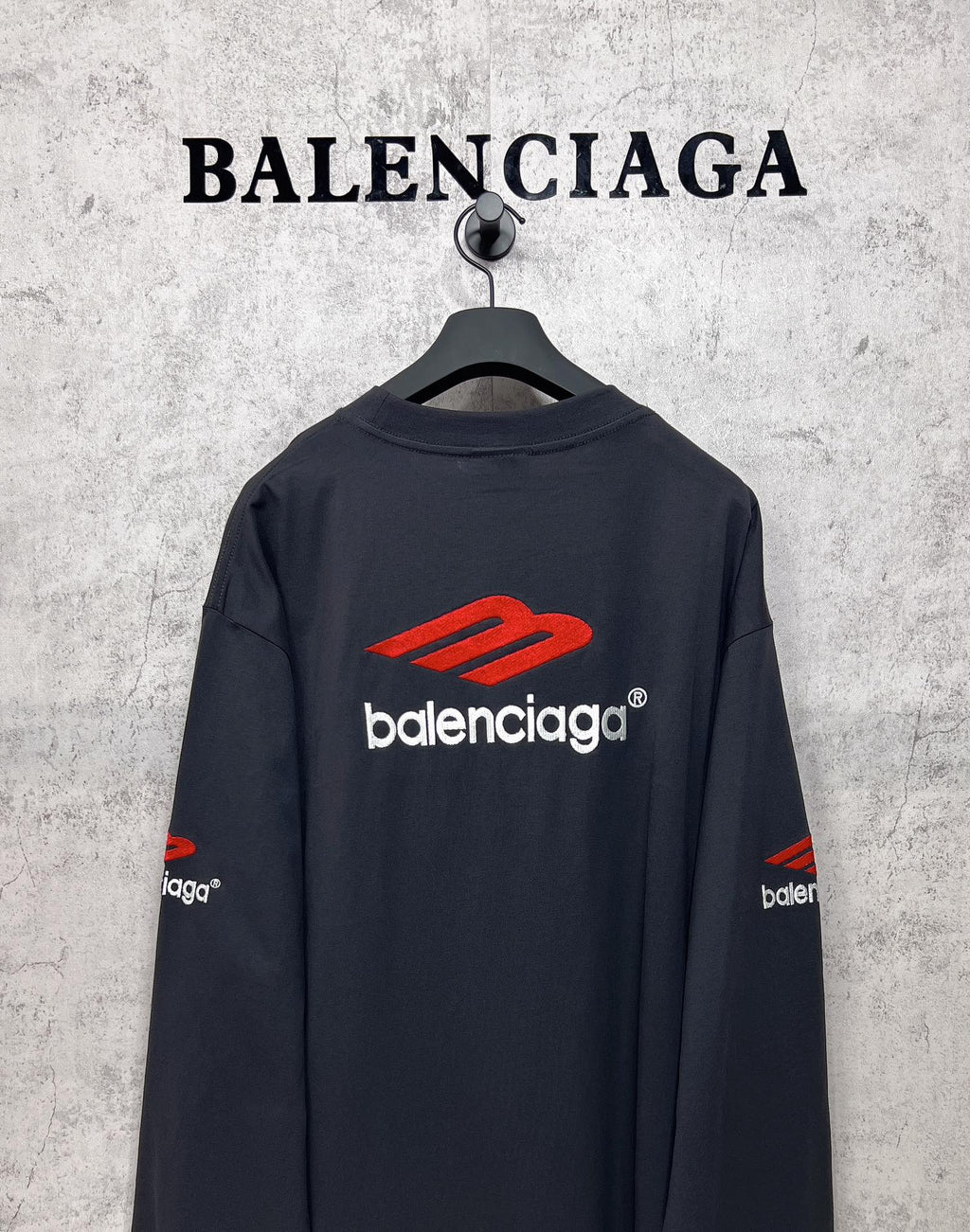 Balenciaga long-sleeve T-shirt, dark navy, back view with red logo and white text centered