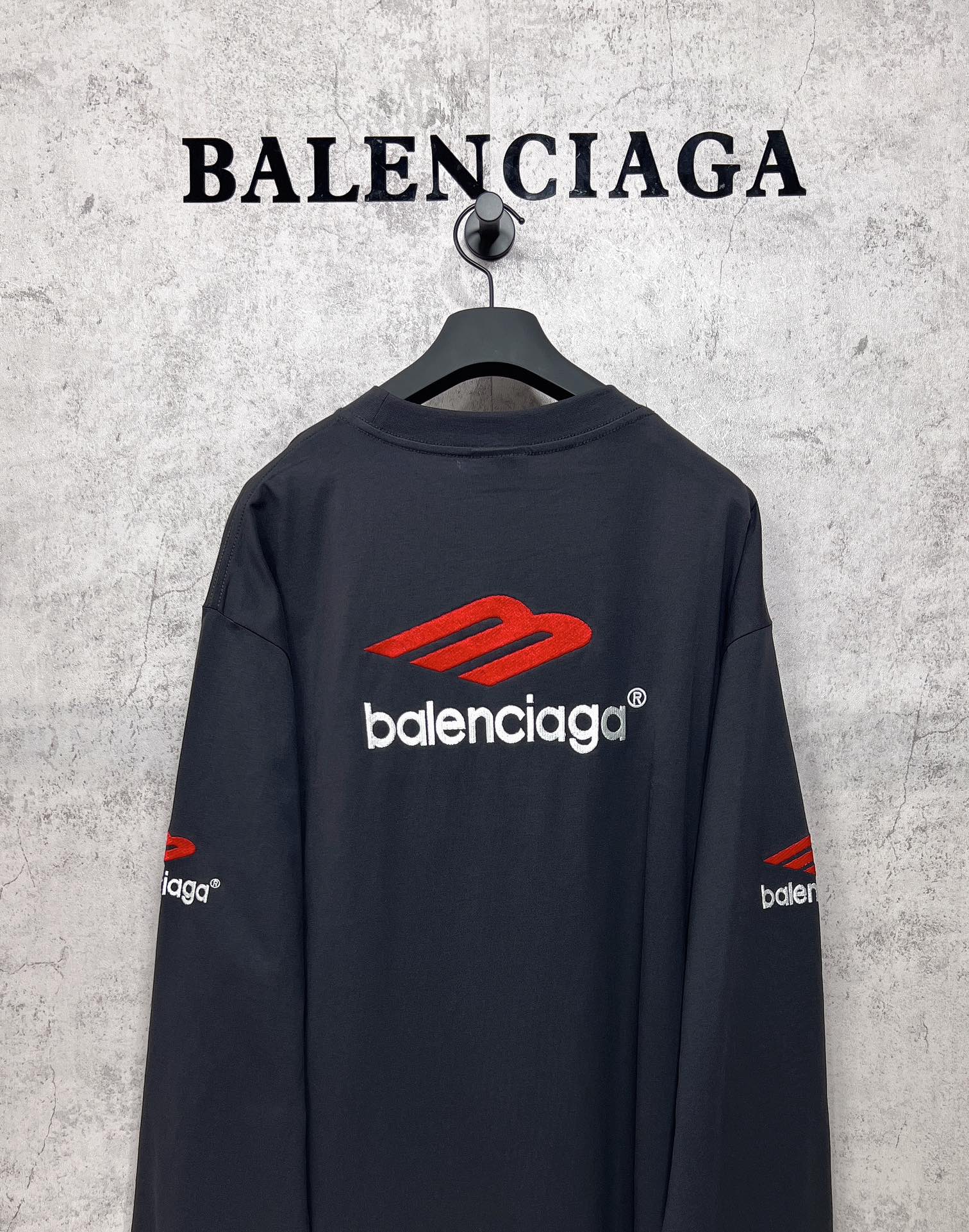 Balenciaga long-sleeve T-shirt, dark navy, back view with red logo and white text centered