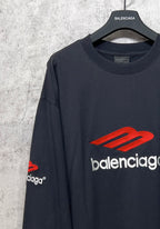 Balenciaga long-sleeve T-shirt, dark navy, angled view showing red logo and white brand text