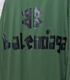 Close-up of green long-sleeve T-shirt with black Balenciaga logo lettering