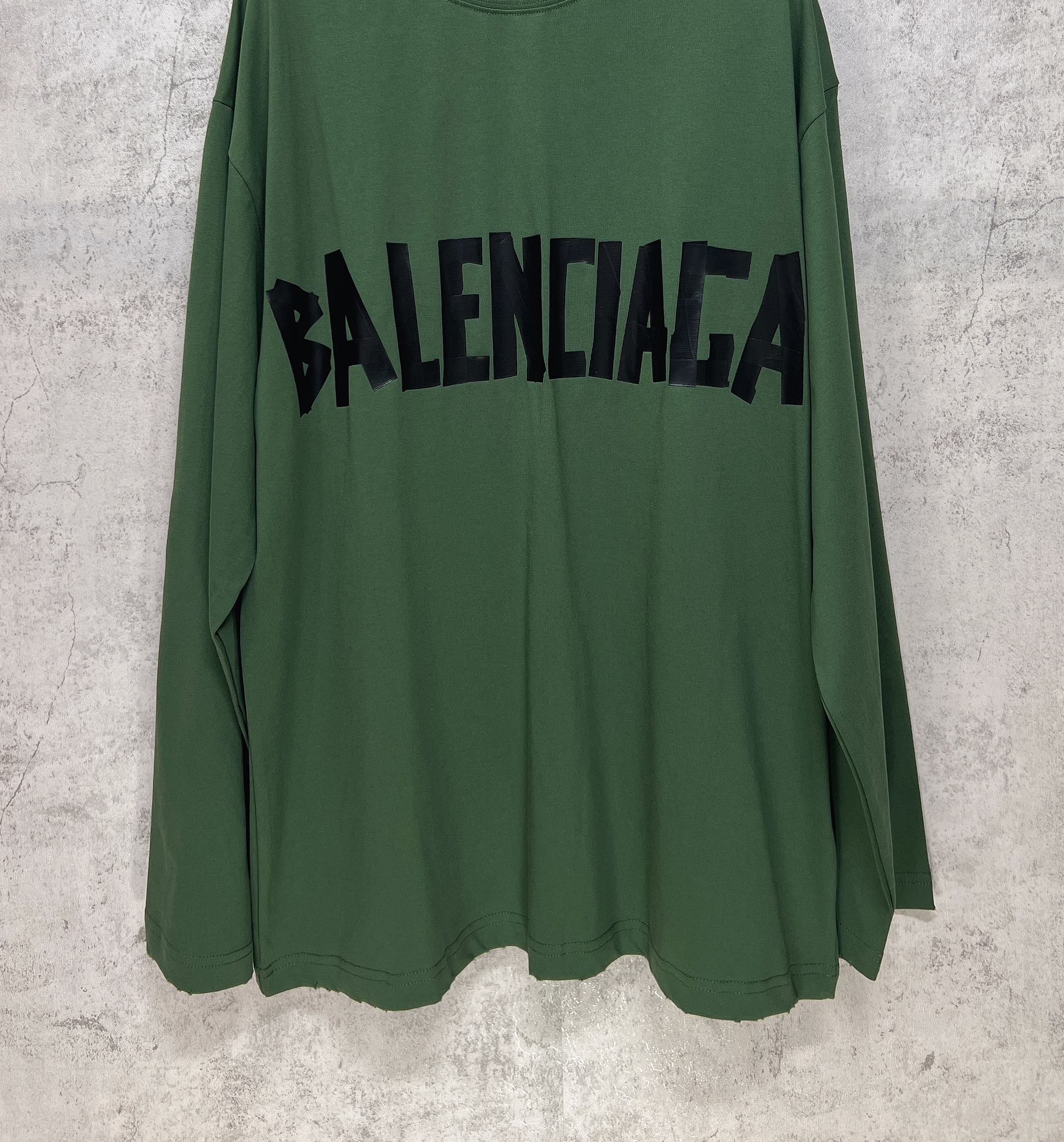 Green long-sleeve T-shirt front view with centered black Balenciaga logo print