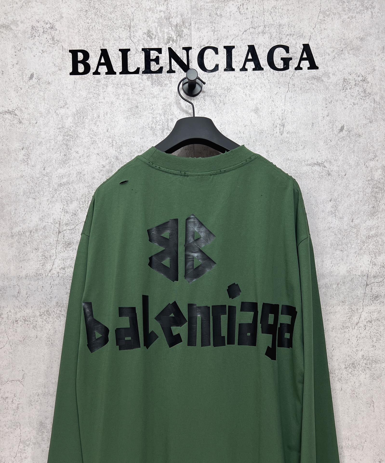 Green long-sleeve T-shirt back view with black Balenciaga logo and emblem print