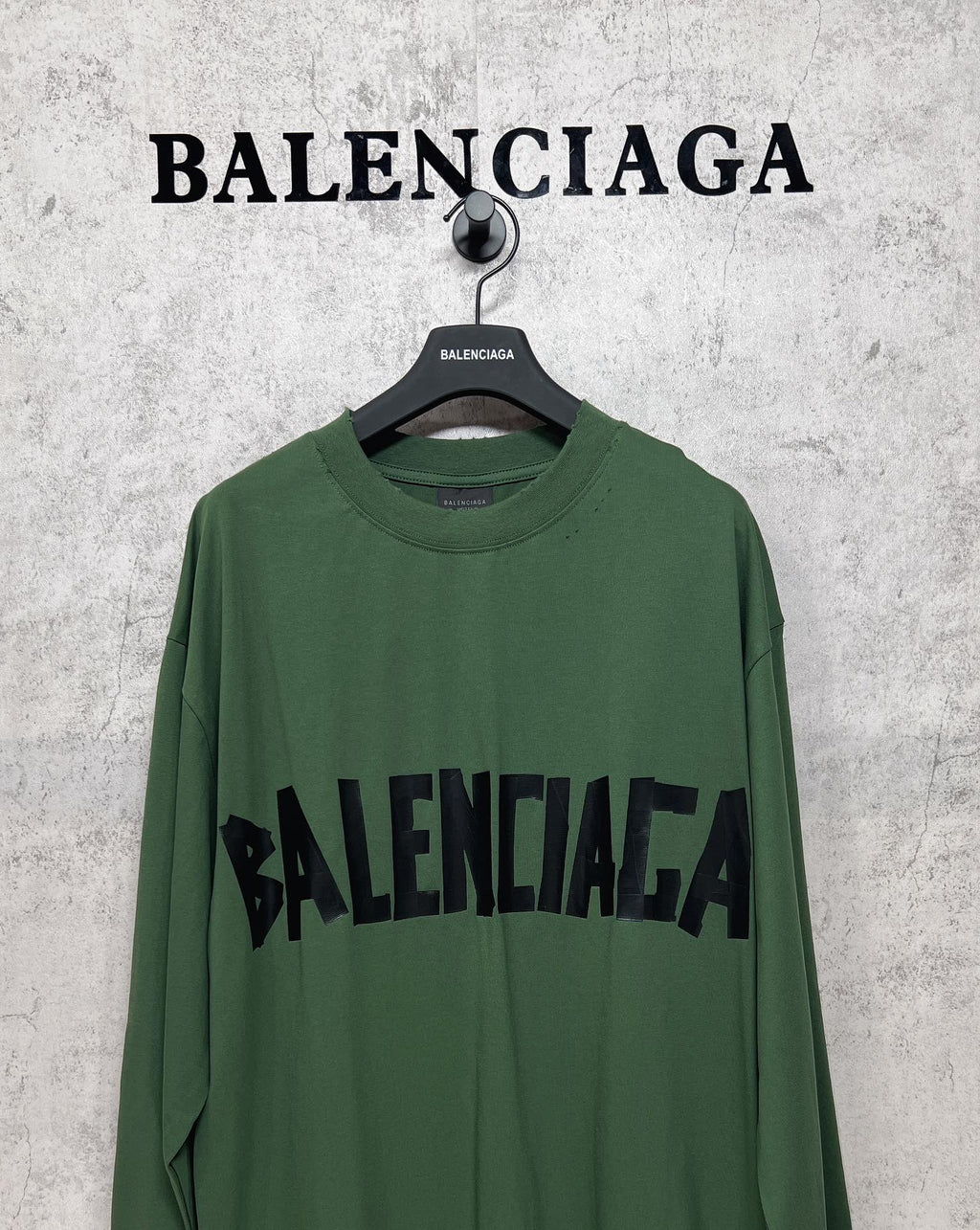 Green long-sleeve T-shirt front view with black Balenciaga logo across the chest