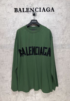 Green long-sleeve T-shirt on hanger with large black Balenciaga logo print