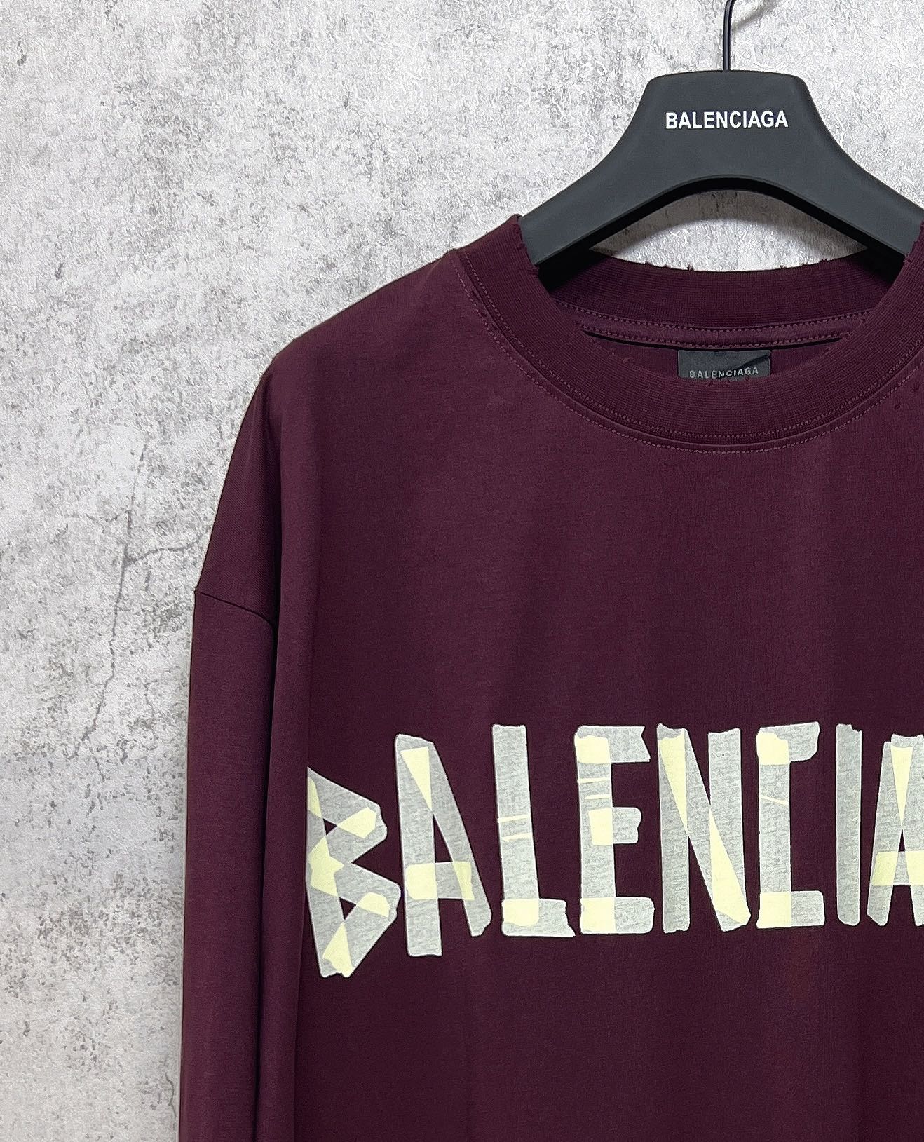Maroon long-sleeve T-shirt with Balenciaga text graphic across chest