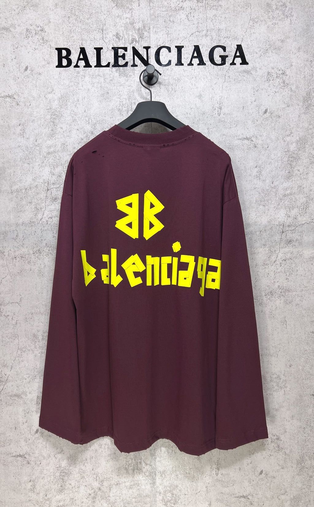Maroon long-sleeve T-shirt with yellow Balenciaga back graphic and symbol