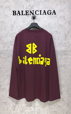 Maroon long-sleeve T-shirt with yellow Balenciaga back graphic and symbol