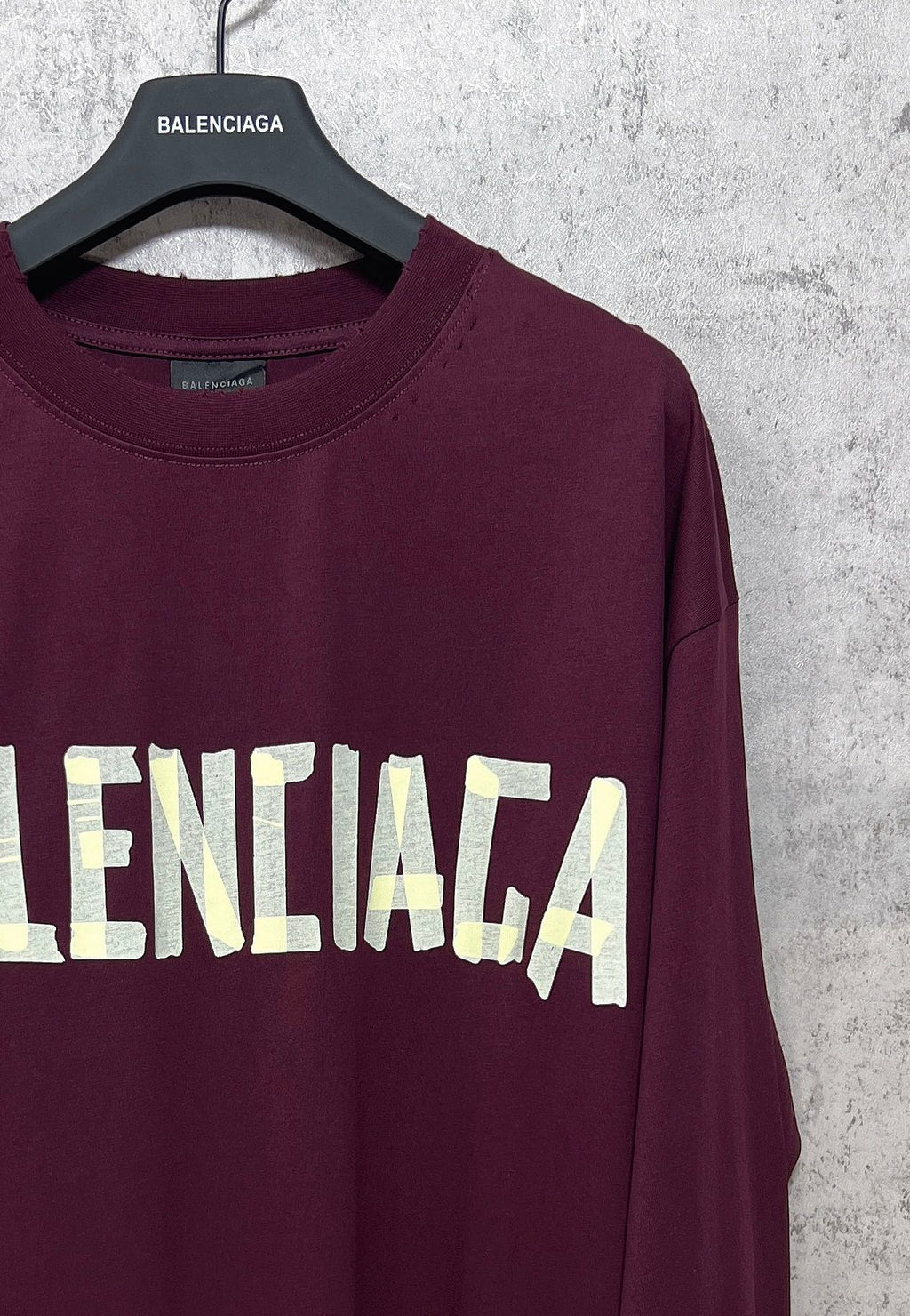 Maroon long-sleeve T-shirt with partial Balenciaga text graphic across front