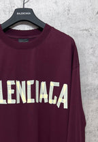 Maroon long-sleeve T-shirt with partial Balenciaga text graphic across front
