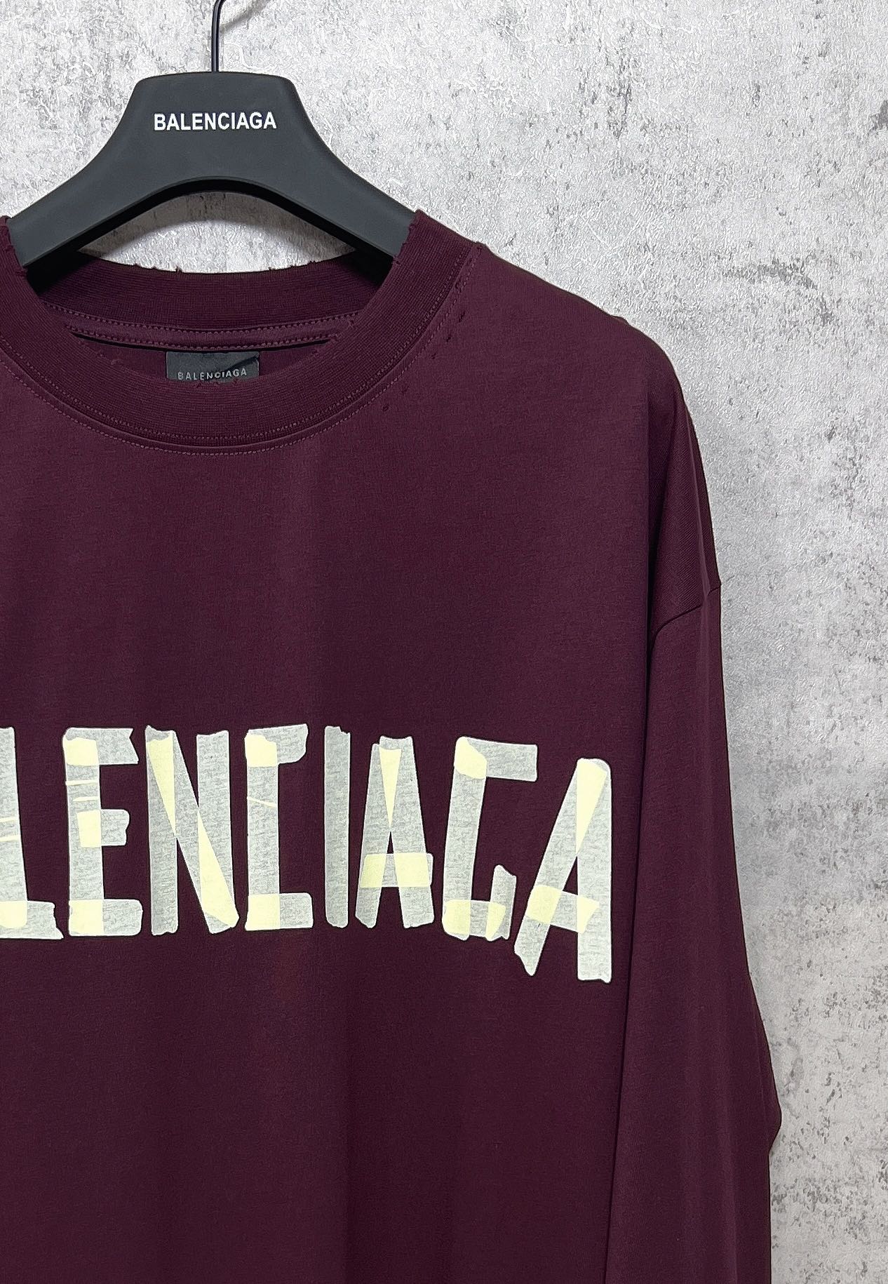 Maroon long-sleeve T-shirt with partial Balenciaga text graphic across front