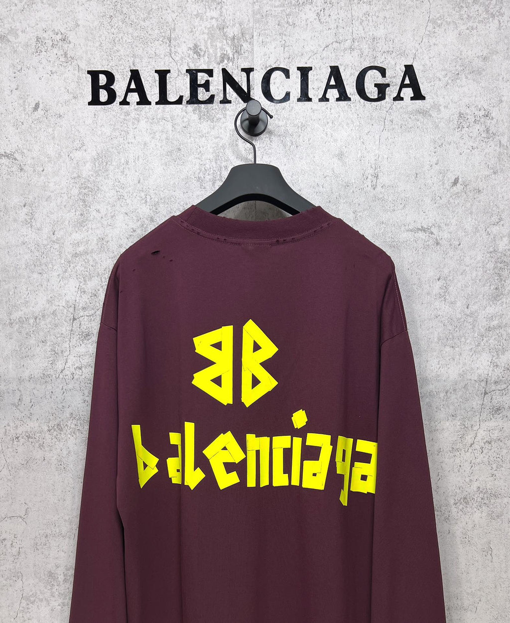 Maroon long-sleeve T-shirt with yellow Balenciaga back logo and symbol