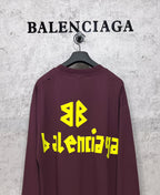 Maroon long-sleeve T-shirt with yellow Balenciaga back logo and symbol