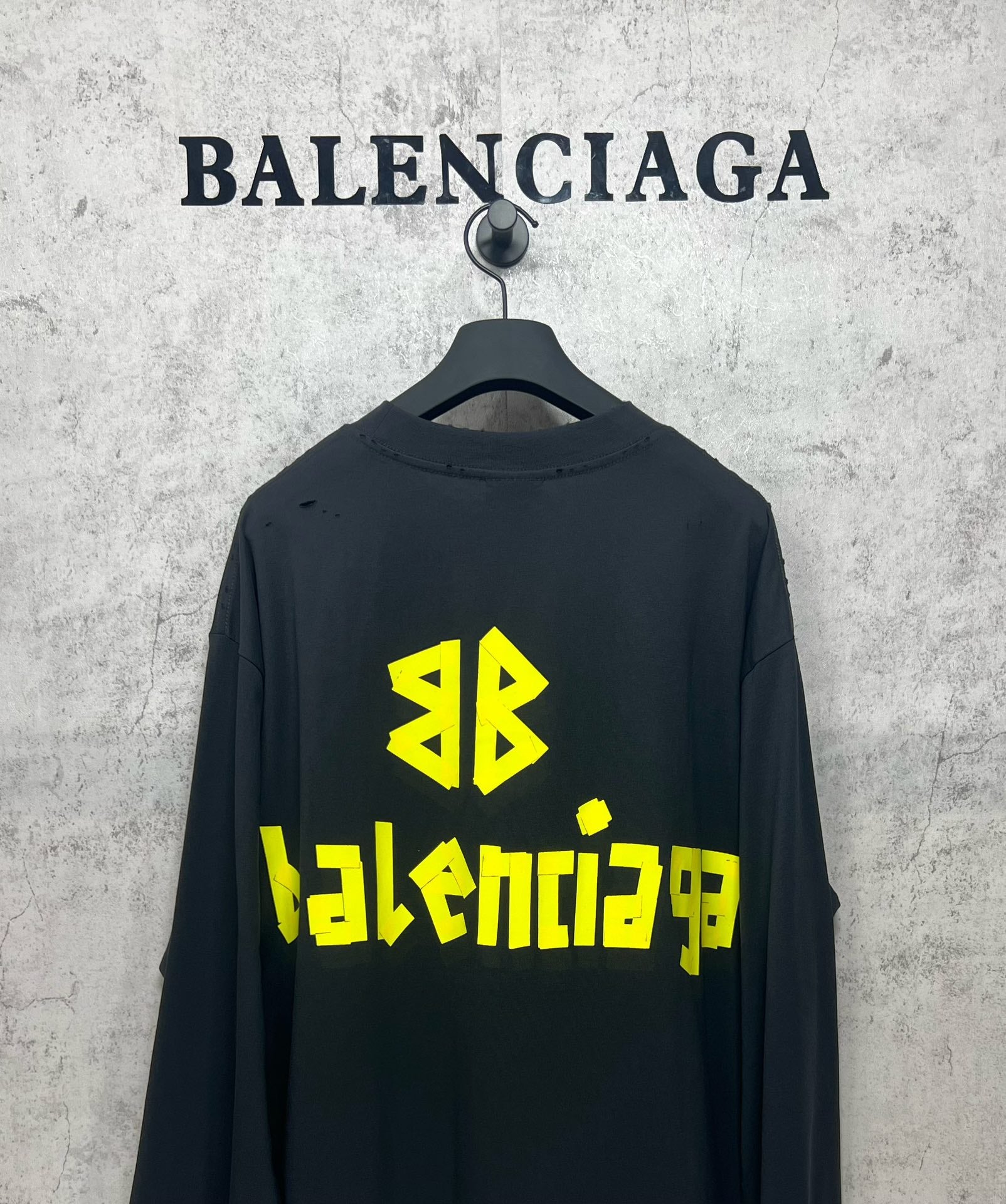 Balenciaga long-sleeve T-shirt on hanger, dark with neon green back logo