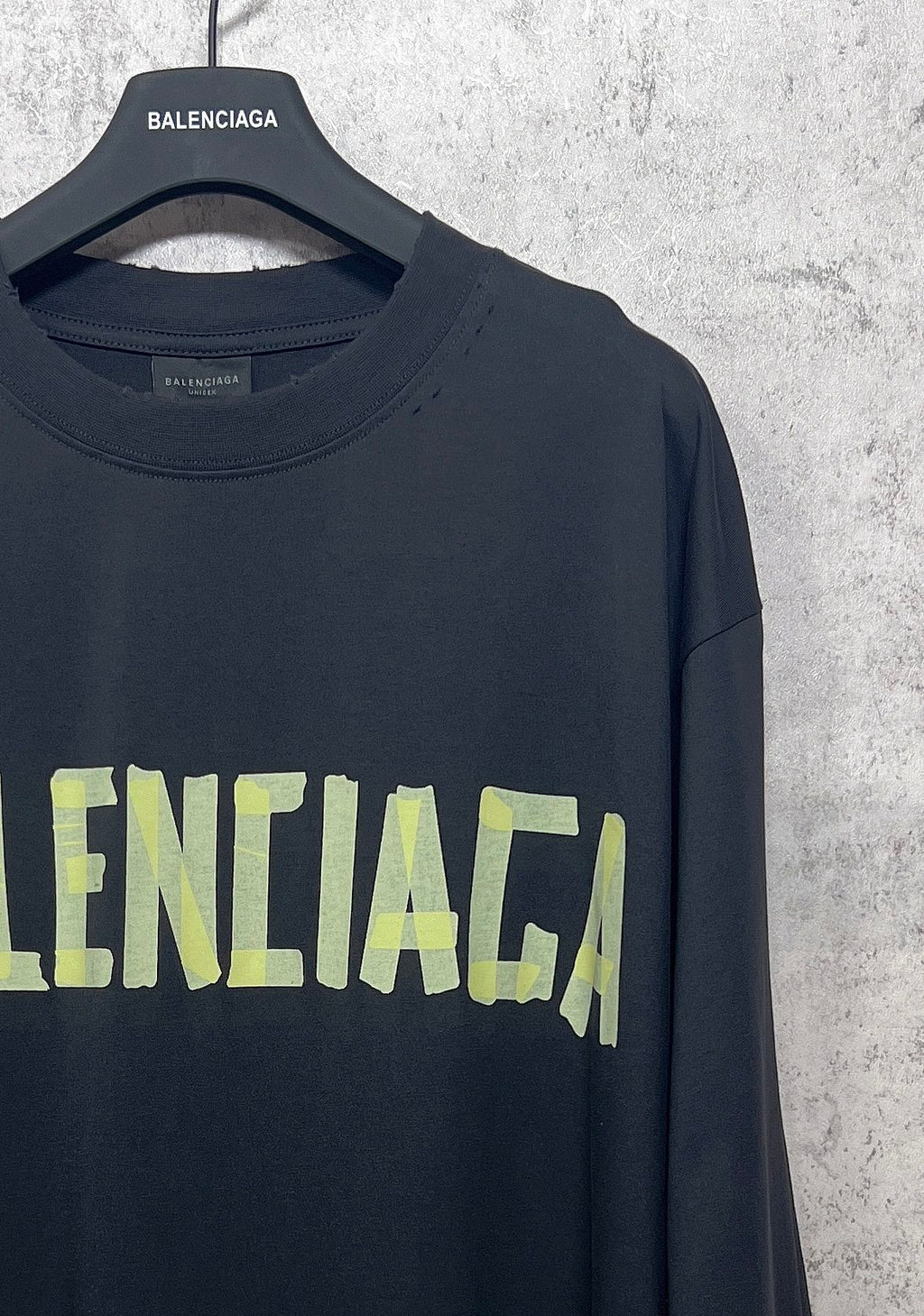 Balenciaga long-sleeve T-shirt with dark fabric and neon green logo on front