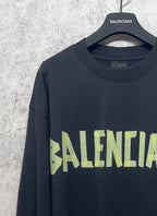 Balenciaga long-sleeve T-shirt, dark with neon green logo print and crew neckline