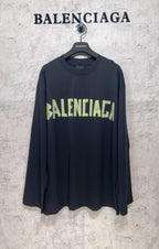 Balenciaga long-sleeve T-shirt, dark with neon green logo print across chest