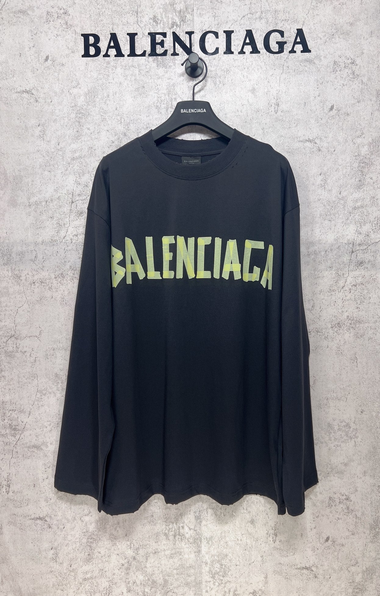 Balenciaga long-sleeve T-shirt, dark with neon green logo print across chest