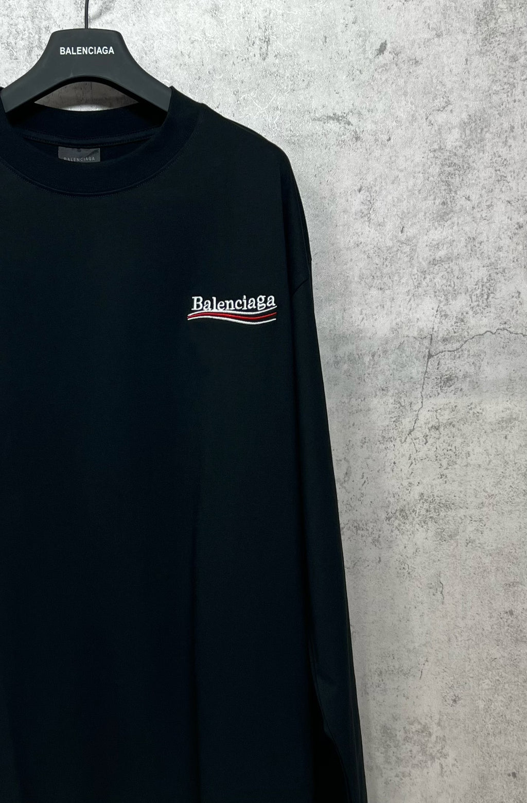 Dark long-sleeve T-shirt with embroidered-style chest logo