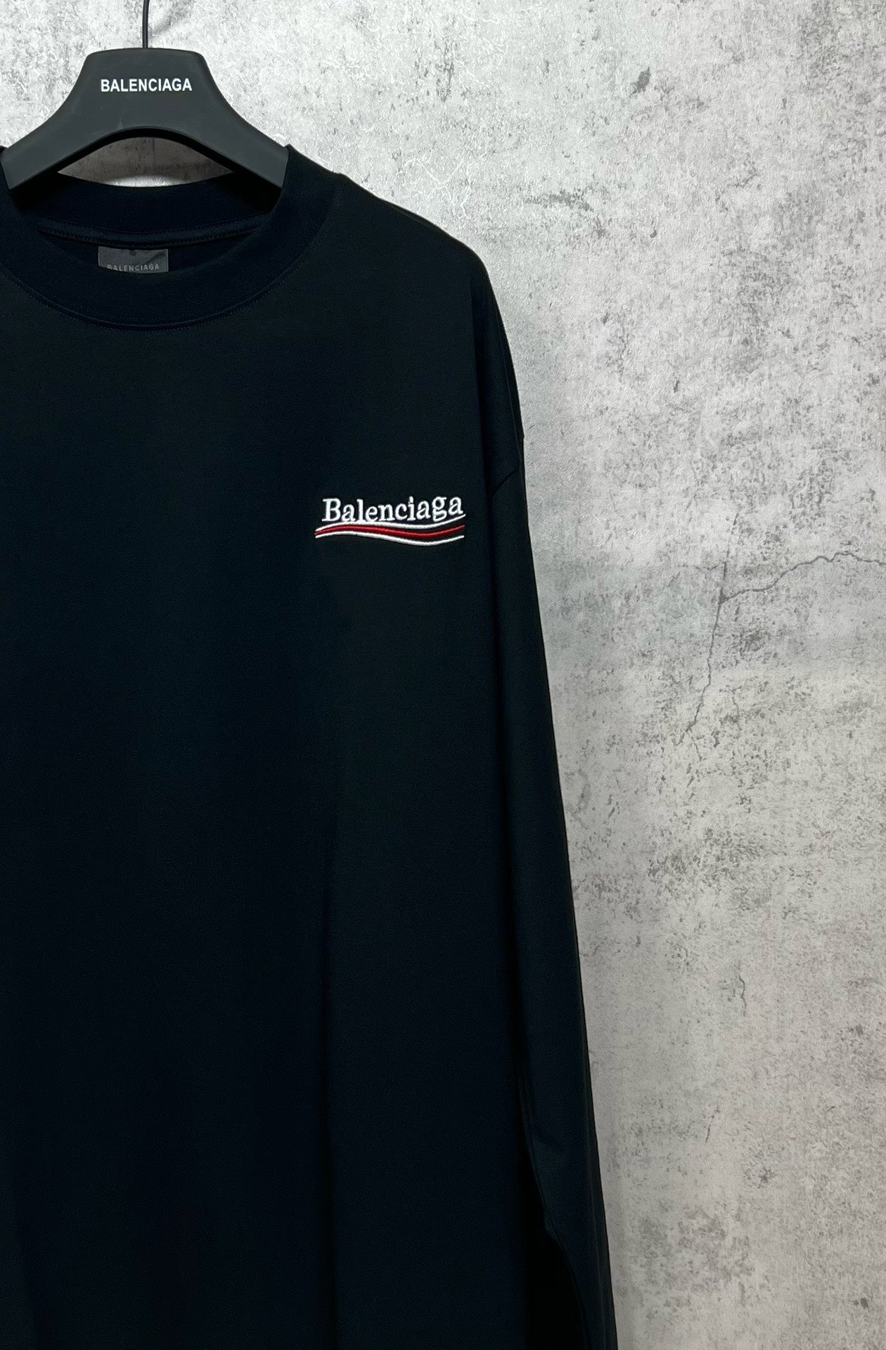 Dark long-sleeve T-shirt with embroidered-style chest logo