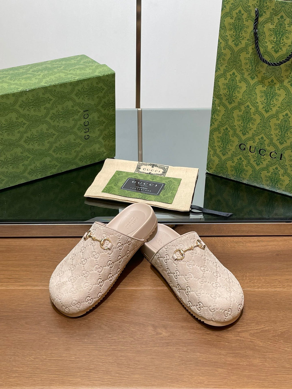 Gucci logo mule sandals, light beige slip-on with gold-tone horsebit accent and cream sole