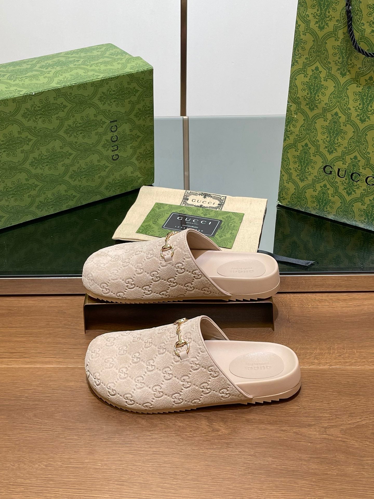 Gucci logo slide sandals, light beige slip-on style with gold-tone horsebit charm