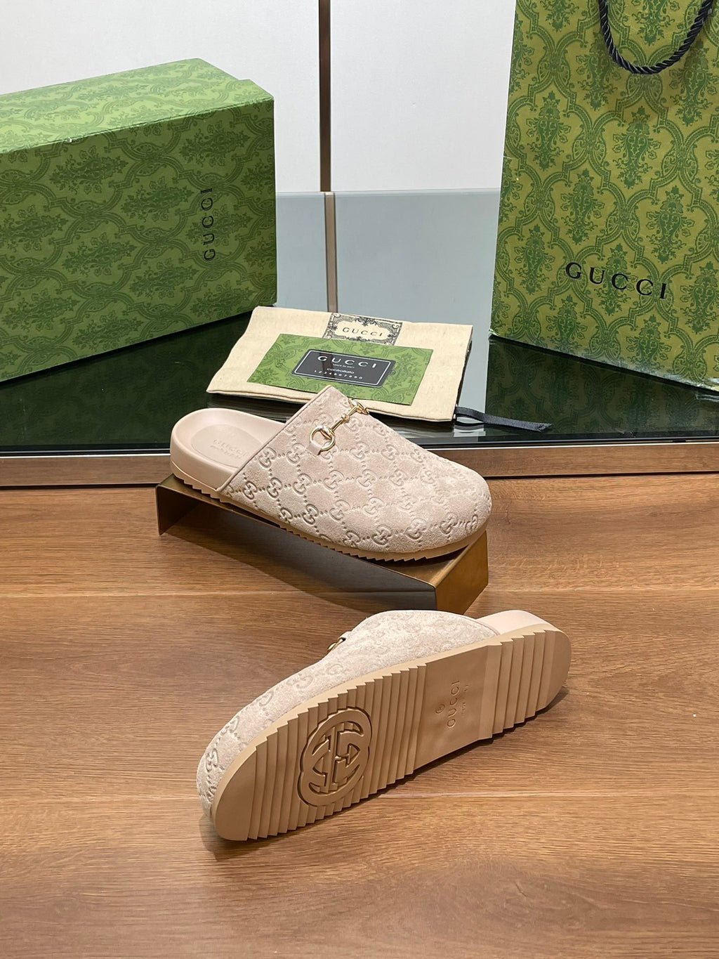 Gucci logo slide sandals, outsole view with light beige tread and interlocking G emblem