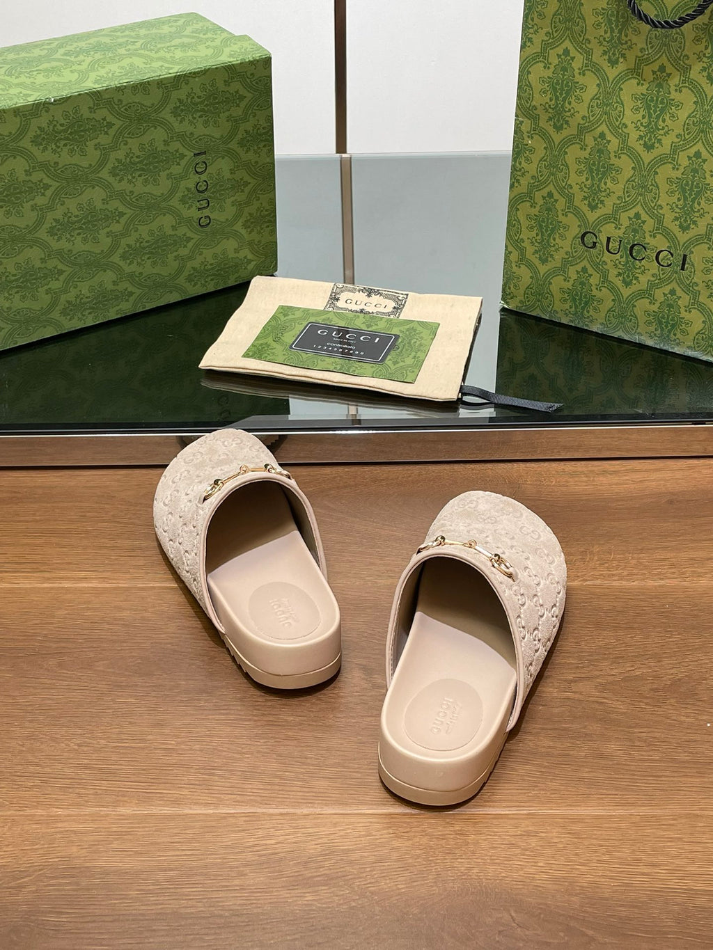 Gucci logo slide sandals, light beige open-back mules with cream footbed and straps