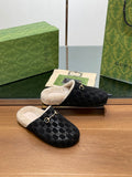 Black monogram mule slippers with beige shearling lining and gold-tone horsebit detail