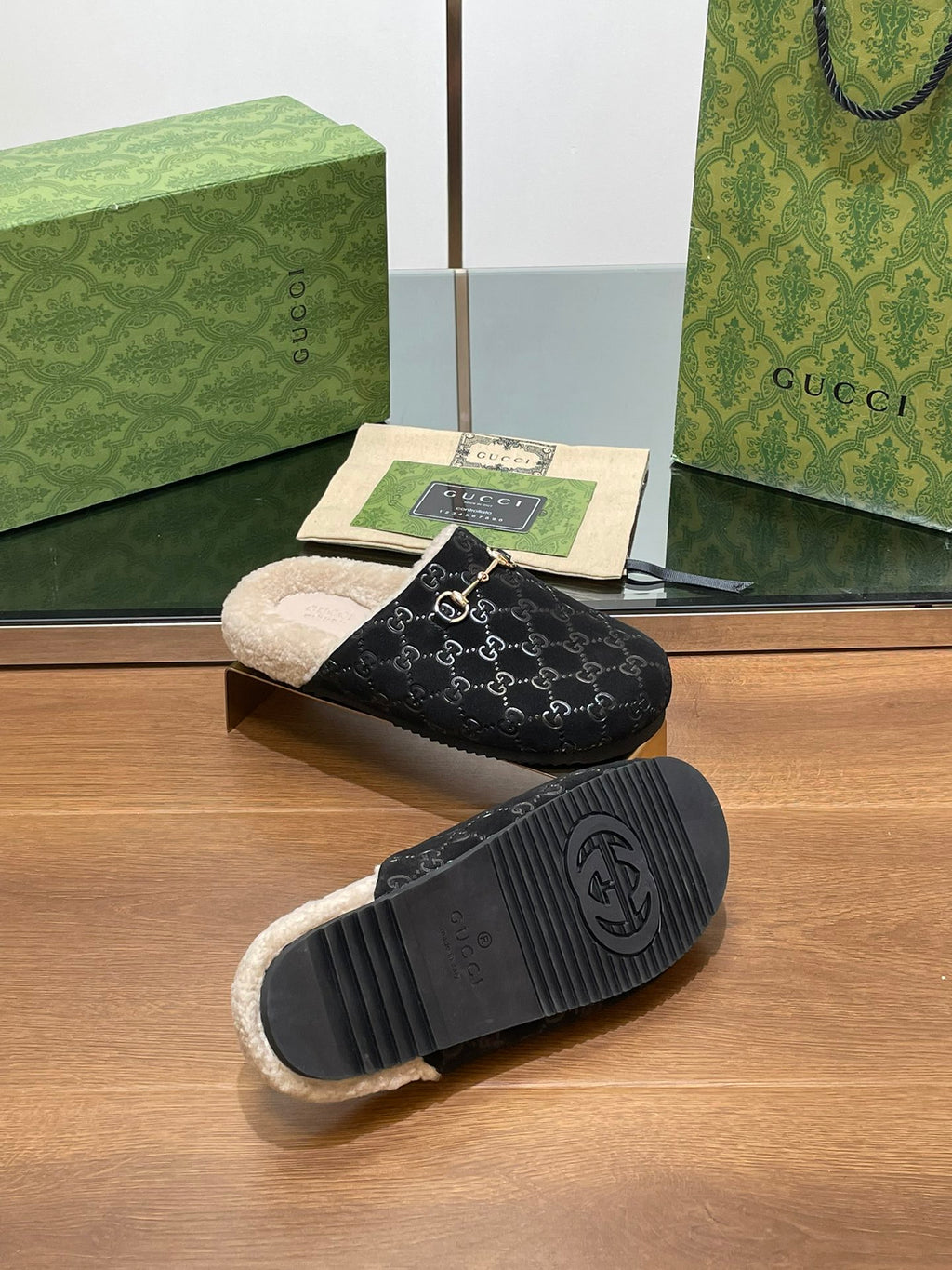Black monogram mule slipper with beige shearling lining and black ridged outsole