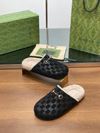 Black monogram mule slippers with beige shearling lining and gold-tone horsebit on top
