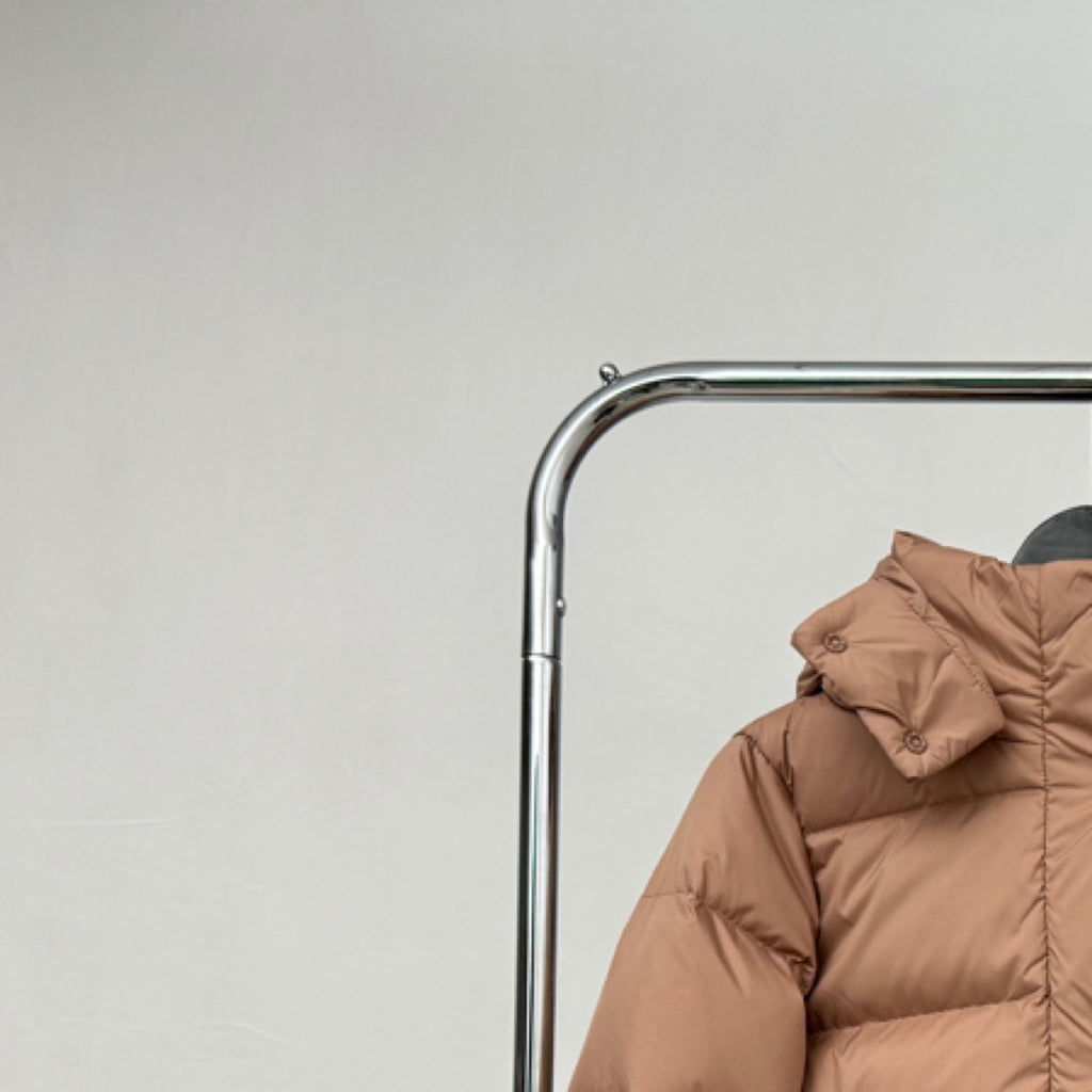 Tan hooded puffer jacket with gathered hood and button detail