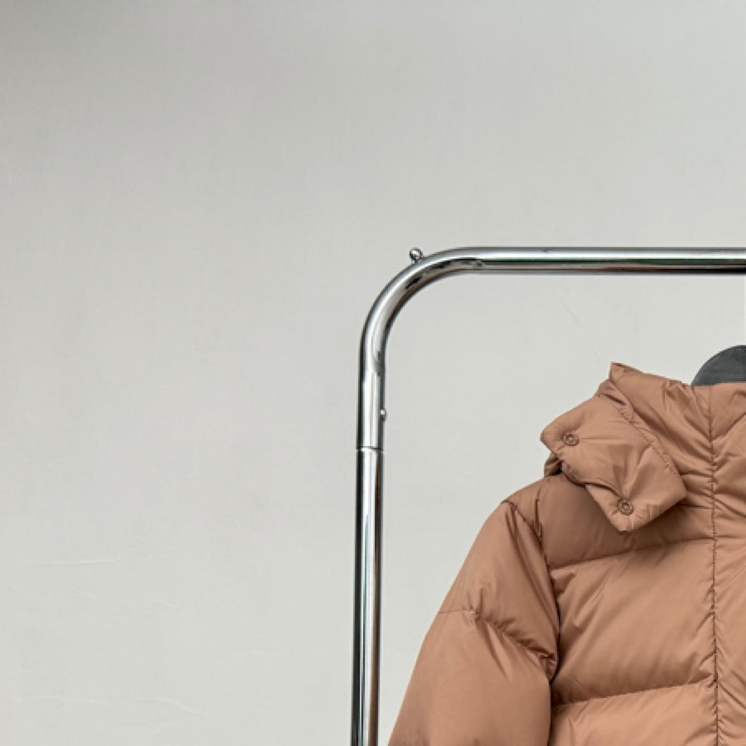 Tan hooded puffer jacket with gathered hood and button detail