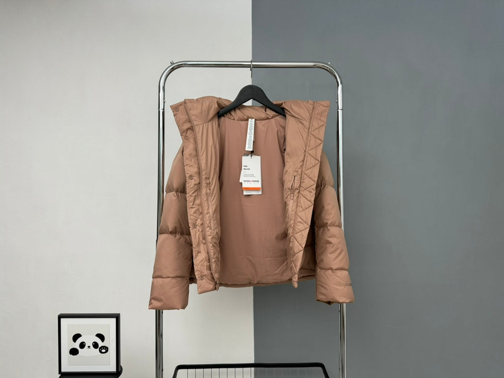 Tan hooded puffer jacket with front buttons and hang tag