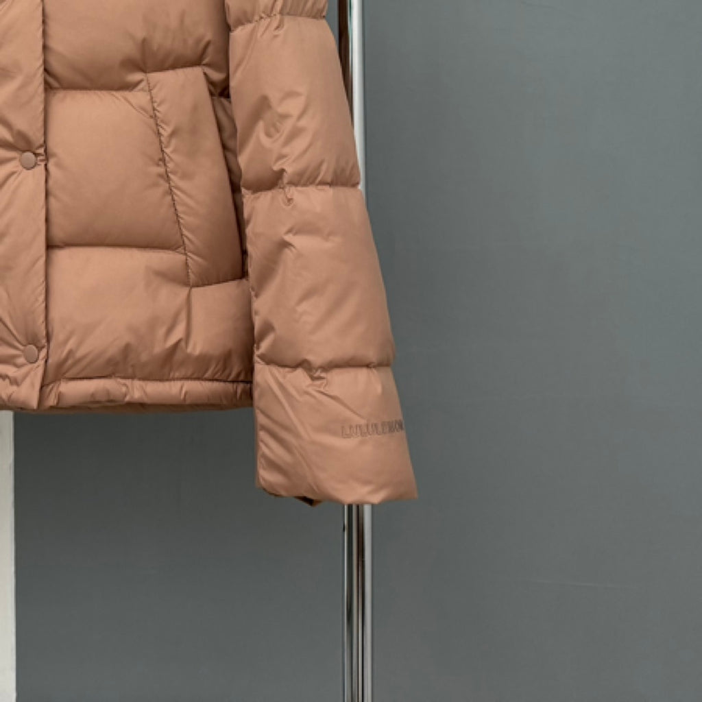 Tan puffer jacket lower sleeve and side seam detail