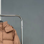 Tan puffer jacket sleeve and shoulder with quilted stitch panels