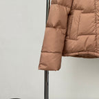 Tan puffer jacket sleeve with quilted stitching and button cuff