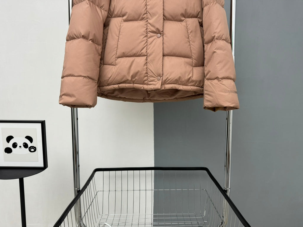 Tan puffer jacket with front buttons and quilted lower hem