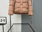 Tan puffer jacket with front buttons and quilted lower hem