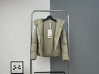 Beige hooded puffer jacket with price tag and front zipper on hanger