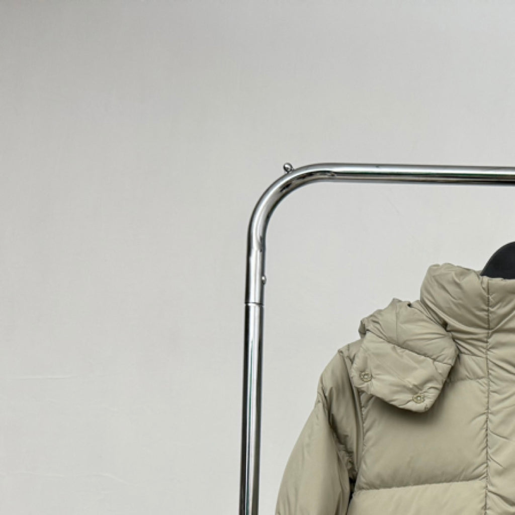 Beige hooded puffer jacket hood and shoulder detail with stitched quilting