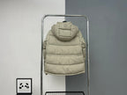 Beige hooded puffer jacket back view with central quilting and attached hood