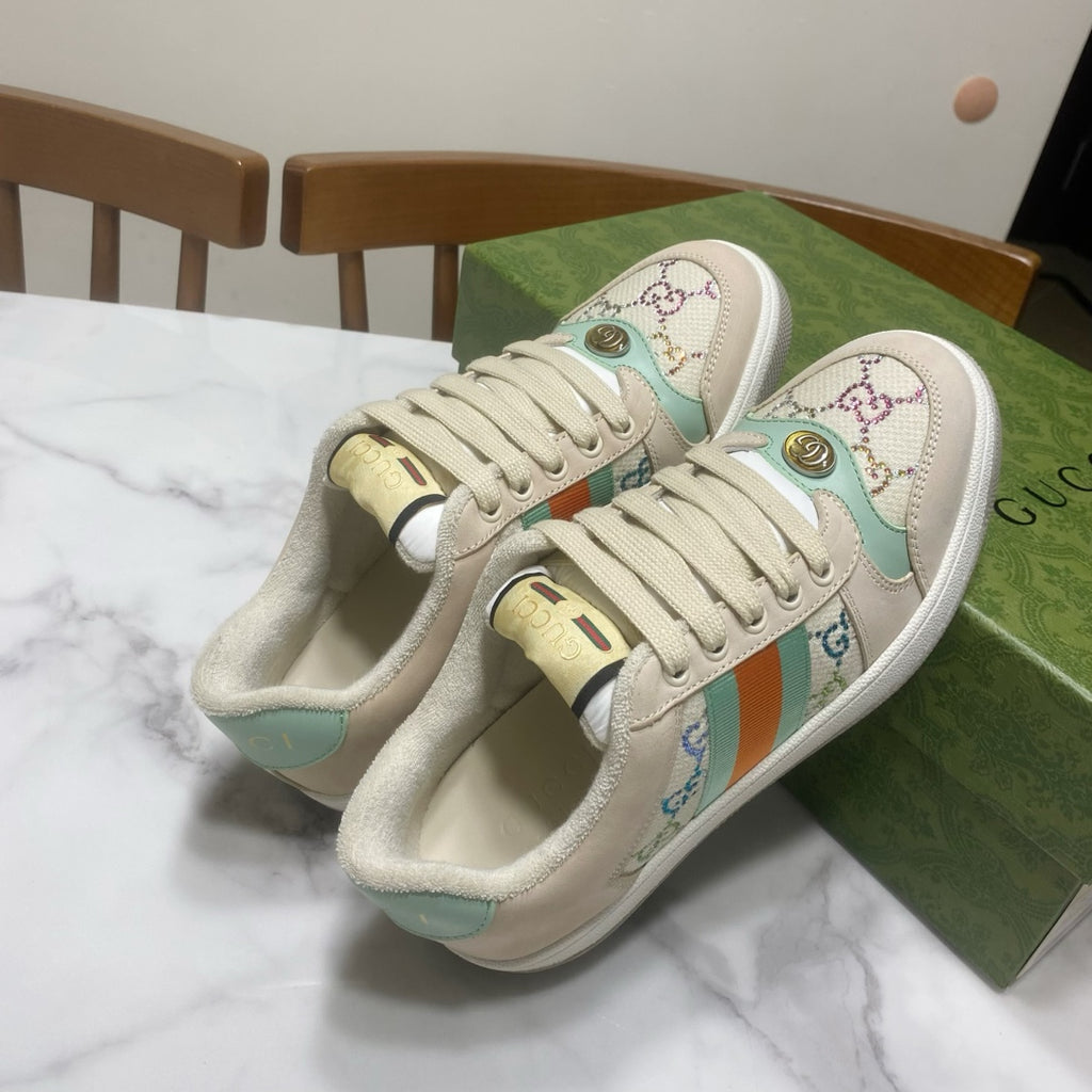 Gucci unisex sneakers, cream with teal panels, gold heel detail, and stripe