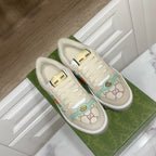 Gucci unisex sneakers, cream with gold emblem and multicolor stripe at side